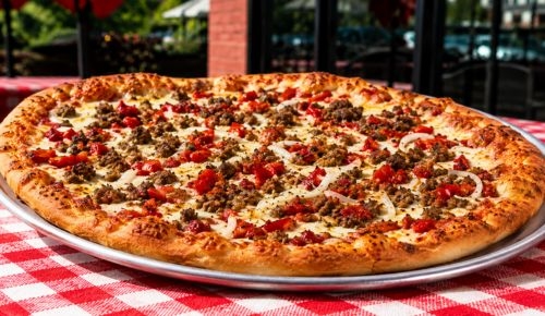 A hand-spun gourmet pizza on a red checkered table at Peppino's Oven